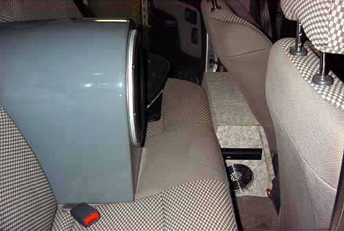 Installed computer case and subwoofer